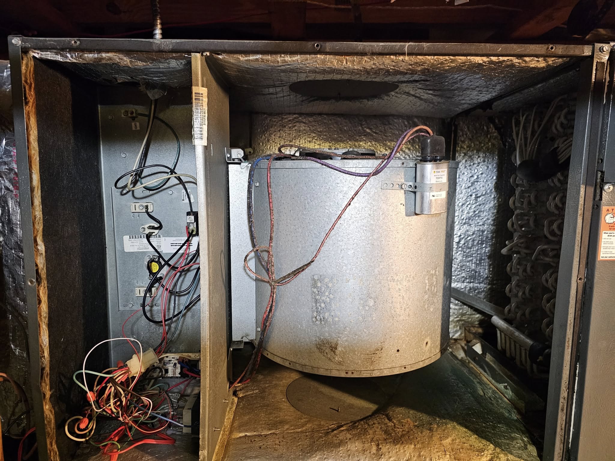 Technician inspecting HVAC unit interior